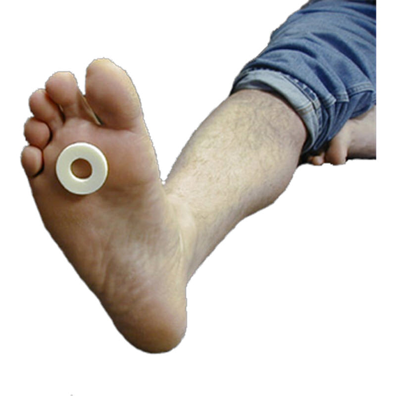 A person&#39;s foot is shown with Dr. Jill&#39;s LW FOOT CARE ADHESIVE FELT RING PAD placed on the small toe, emphasizing foot care. The person is wearing rolled-up denim jeans, which stylishly contrast with the white, circular pad designed for calluses.