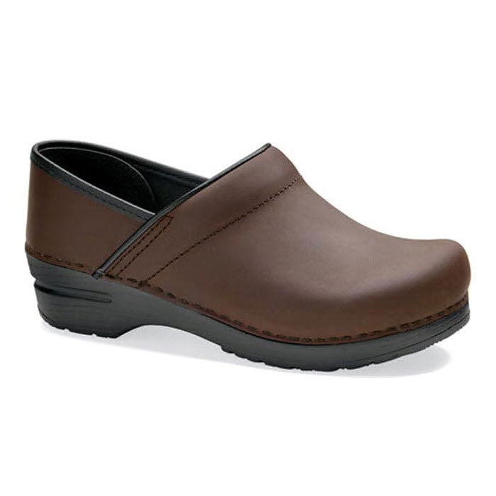 A single brown leather clog with a black sole, featuring a closed toe, low heel, and Dansko&#39;s signature rocker-bottom design – the DANSKO PROFESSIONAL BROWN OILED - ADULTS by Dansko is the perfect professional shoe.