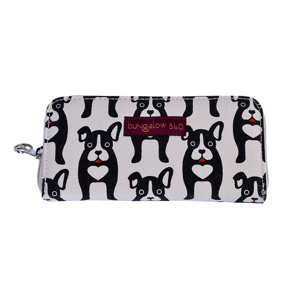 The BUNGALOW 360 ZIP AROUND WALLET BLACK DOGS by Bungalow 360 is a 100% vegan wallet made from durable natural cotton canvas, featuring a black and white dog pattern and a small red label that reads "bungalow 360.