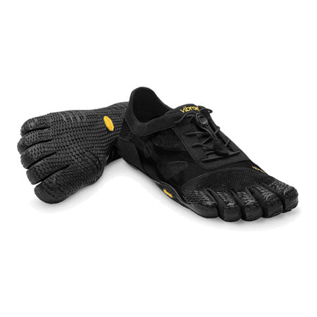 A pair of black Five Fingers VIBRAM FIVE FINGERS KSO EVO - WOMENS shoes featuring individual toe pockets, yellow logo detail, and textured soles designed for optimal ground feedback.