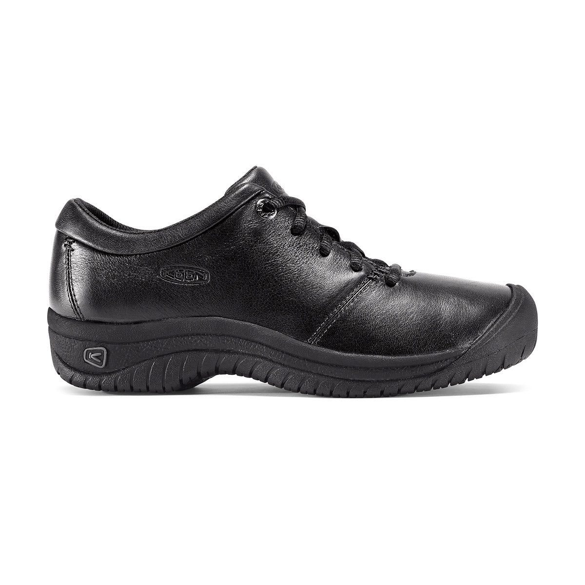 A side view of a black lace-up work shoe with a rubber non-slip sole for all-day comfort, the KEEN PTC OXFORD BLACK - WOMENS by Keen.