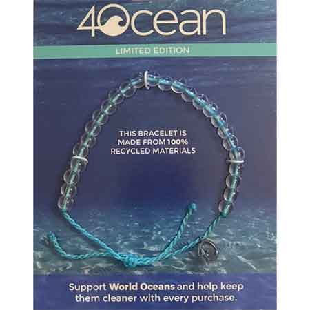 A limited edition 4OCEAN BRACELET WORLD OCEAN DAY LIMITED EDITION, crafted from 100% recycled materials by 4Ocean, supporting a sustainable future for World Oceans, showcased against the backdrop of serene ocean waves.