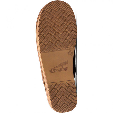 The Dansko Professional Honey Distressed - Womens features a brown rubber sole with a herringbone tread pattern and a label showing &quot;Dansko&quot; in the center. This full-grain leather clog offers all-day support for exceptional comfort.