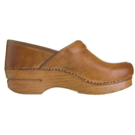 A brown full-grain leather clog with a wooden sole, viewed from the side, reminiscent of the renowned Dansko Professional line known for its all-day support is the DANSKO PROFESSIONAL HONEY DISTRESSED - WOMENS by Dansko.