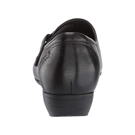 Rear view of a Dansko DANSKO FRANNY MILLED NAPPA BLACK - WOMENS shoe with a low wedge heel, seam detailing, and an adjustable hook and loop instep closure.