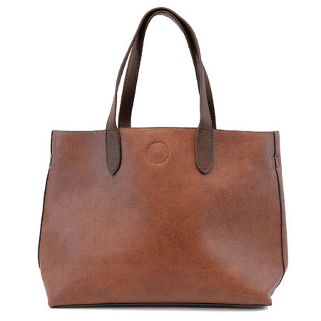 A medium-sized JOY SUSAN NEW MARIAH TOTE COGNAC in brown vegan leather with dual handles and a simple design by Joy Susan.