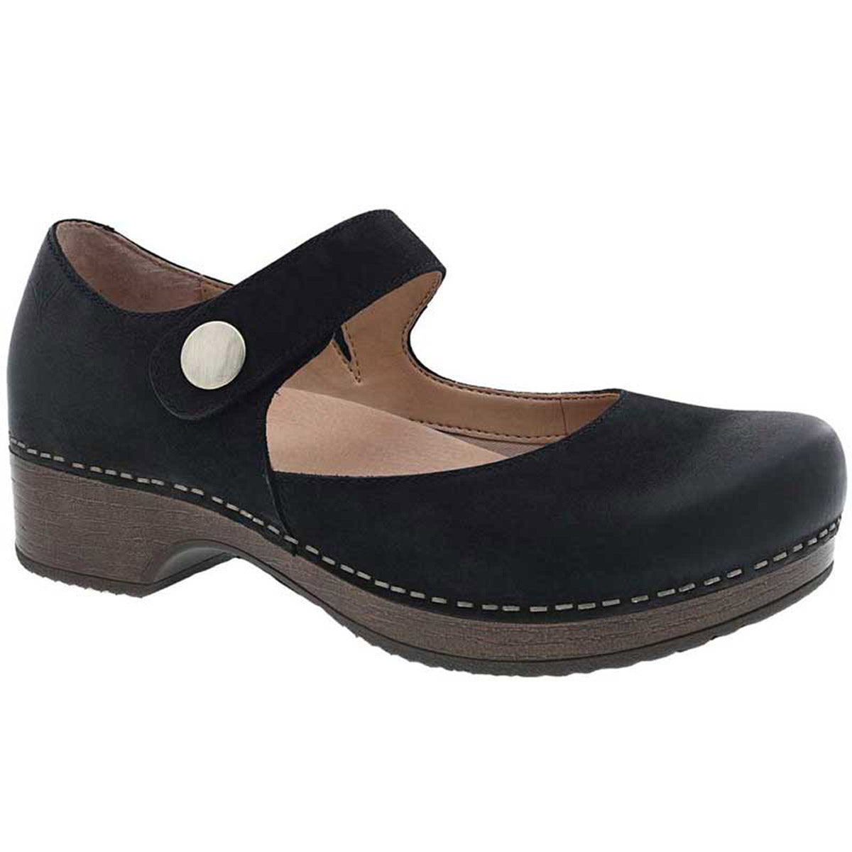 The Dansko Beatrice Black Burnished - Womens is a black Mary Jane shoe with a silver button, a brown wedge heel, and white stitching along the sole. It features a cutout on the side of the strap and lightweight EVA outsole for added comfort. The hook and loop adjustability ensures a perfect fit.