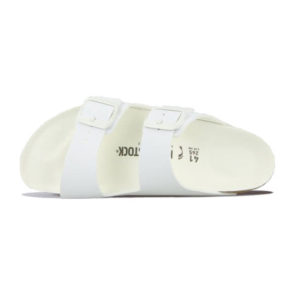 A pair of BIRKENSTOCK ARIZONA WHITE BIRKOFLOR - WOMENS, featuring a two-strap design with buckles and an anatomically shaped footbed from Birkenstock.