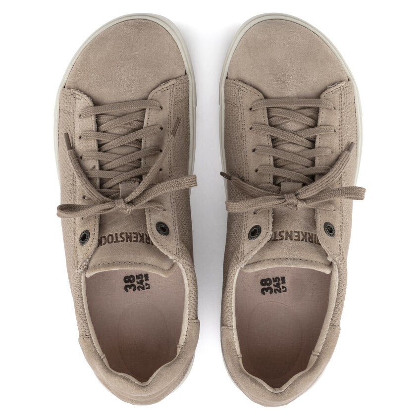 A pair of Birkenstock BIRKENSTOCK BEND SANDCASTLE CANVAS - WOMENS with laces, viewed from above. The brand name is visible on the insoles. These women&#39;s shoes feature an anatomically shaped cork-latex footbed for added comfort.