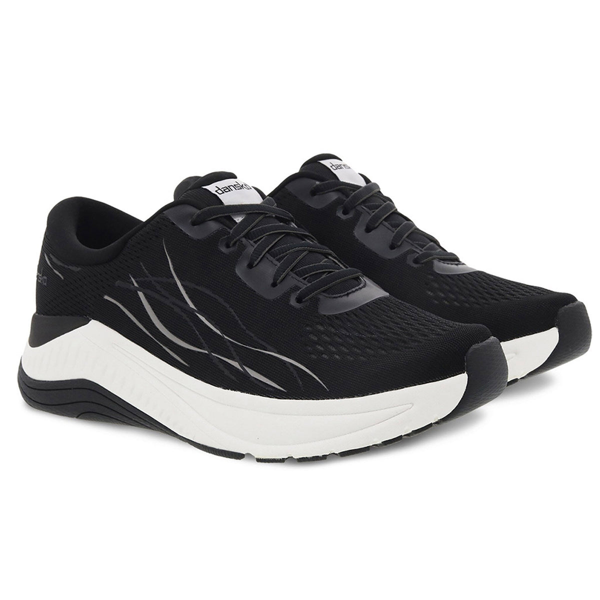 The DANSKO PACE BLACK MESH - WOMENS walking shoes, featuring a sleek design with black mesh uppers and white soles, come with lace-up closures and the iconic Dansko logo on the tongues. These shoes are equipped with Natural Arch Plus technology to provide enhanced comfort and support.