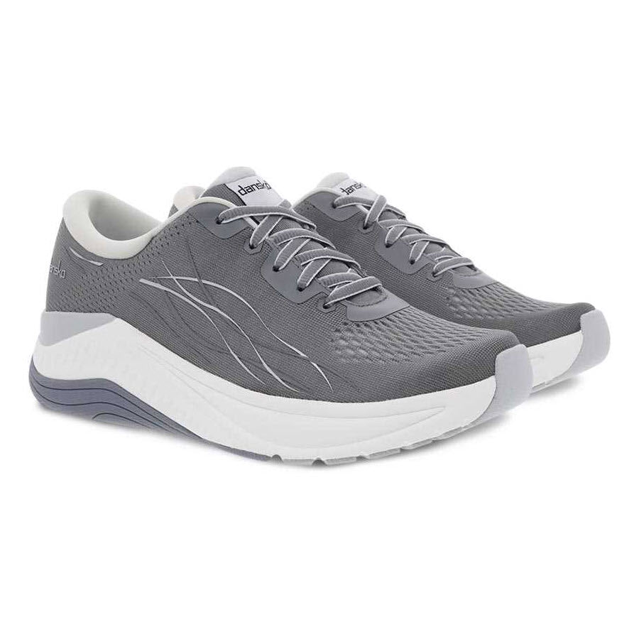 The DANSKO PACE GREY MESH - WOMENS shoes from Dansko are a pair of gray athletic shoes with white soles. They feature a lace-up closure, incorporate Dansko&#39;s Natural Arch Plus technology for enhanced support, and have a breathable mesh upper design.