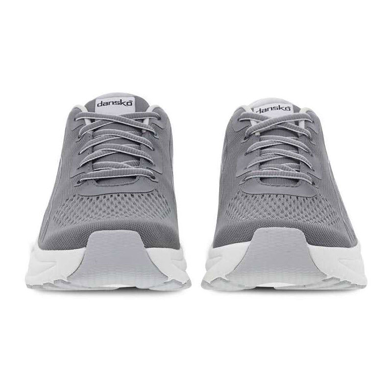 Introducing the DANSKO PACE GREY MESH - WOMENS: A pair of gray athletic shoes with white soles, featuring laces and a breathable mesh upper, viewed from the front. These shoes are equipped with Dansko&#39;s Natural Arch Plus technology for enhanced support.