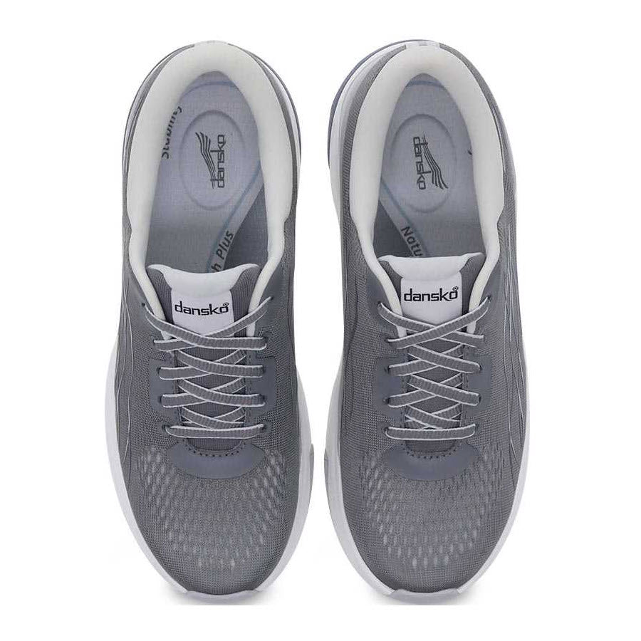 A pair of DANSKO PACE GREY MESH walking shoes for women, with white soles, gray laces, and the &quot;Dansko&quot; branding visible on the tongue, featuring Aegis Microbe Shield and Dansko Natural Arch Plus technology for ultimate comfort.