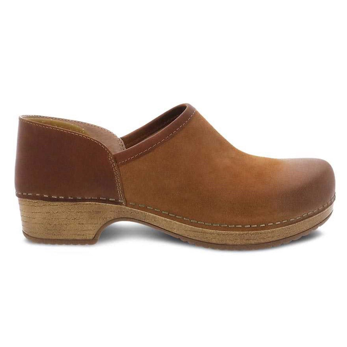 Side view of a brown leather Dansko Brenna Tan Burnished Suede - Womens clog, a comfortable casual slip-on shoe with a wooden sole and small heel.