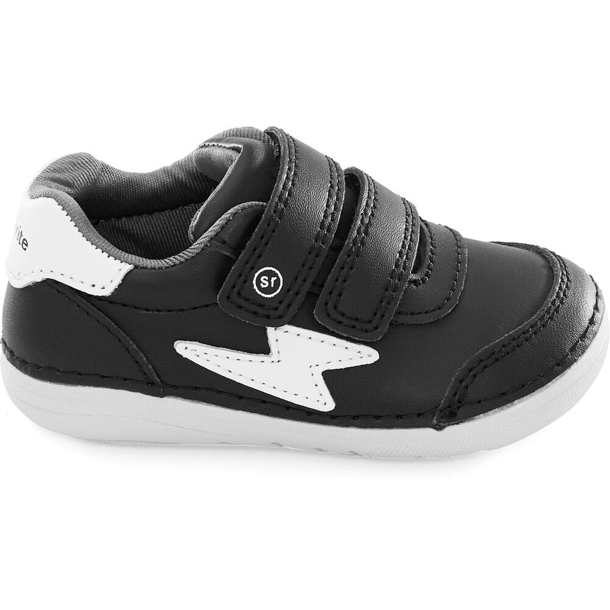 The STRIDE RITE SM KENNEDY BLACK - KIDS from Stride Rite is a black children&#39;s sneaker featuring two velcro straps, a white lightning bolt design on the side, a white sole, and memory foam insoles for extra comfort.