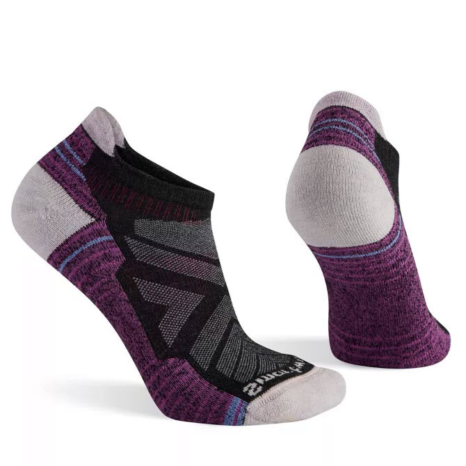 Two Smartwool Performance Low Hiker Socks Charcoal - Womens displayed; one showing the top design with black, purple, and gray patterns, utilizing Indestructawool technology for durability. The other reveals the heel and sole with purple and gray colors, perfect for hiking adventures.