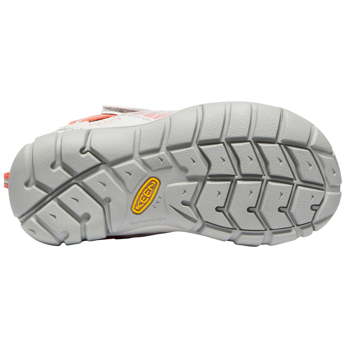 Close-up view of the outsole of a KEEN CHANDLER CNX CHILD DRIZZLE/DUBARRY - KIDS sneaker by Keen, featuring a textured tread pattern and an orange logo.