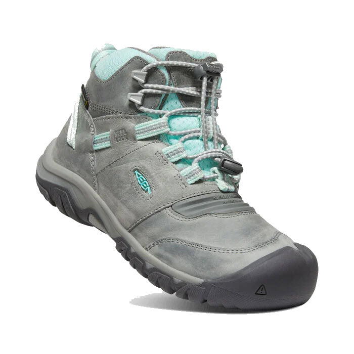 The Keen KEEN Ridge Flex Mid Child Grey/Blue Tint - Kids is a grey hiking boot with teal accents, featuring sturdy rubber soles, a padded collar for extra comfort, ankle support, and a lace-up design with an adjustable toggle and pull-cinch closure.