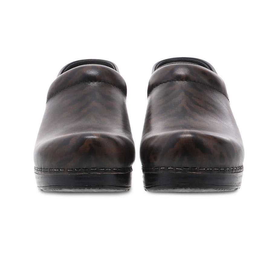 Front view of a pair of dark brown Dansko Professional Zebra Brush Off - Womens closed-toe clogs with subtle stitching and flat soles, featuring an anti-fatigue rocker bottom for all-day comfort.
