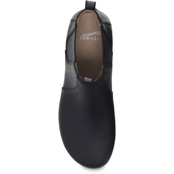 Top view of a single Dansko DANSKO BECKA BLACK - WOMEN leather low bootie with a smooth finish, featuring a slightly pointed toe and a minimalist design.