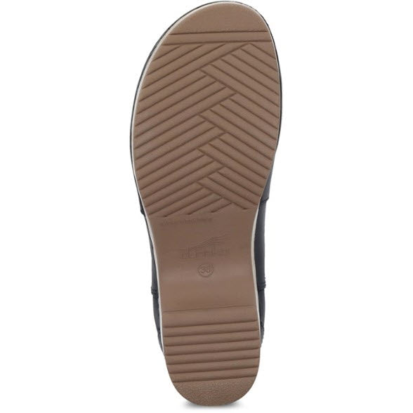 The image shows the sole of a shoe with a chevron tread pattern and a light brown color, typical of Dansko DANSKO BECKA BLACK - WOMEN boots featuring Nubuck uppers.