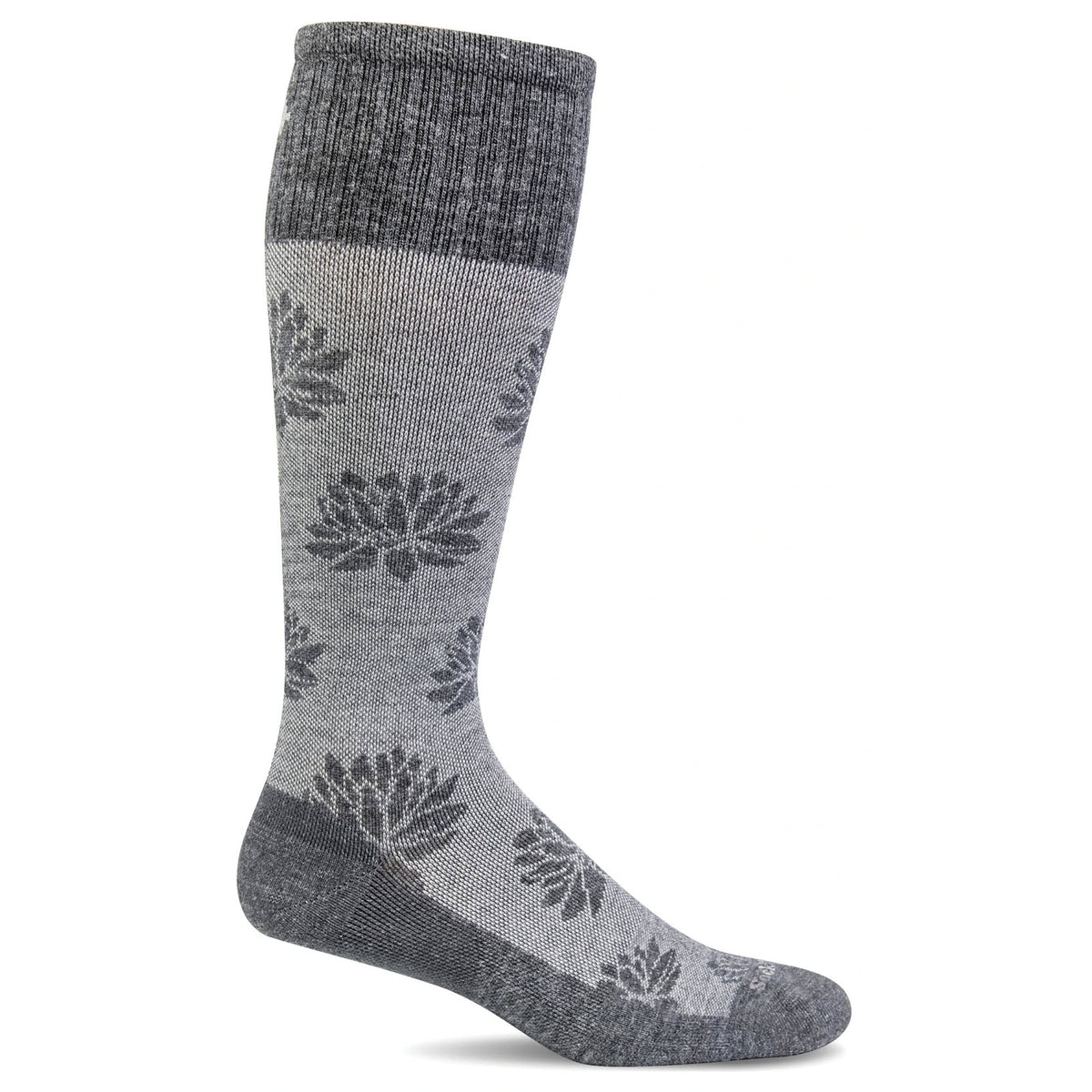 A single grey knee-high Sockwell SOCKWELL LOTUS LIFT CHARCOAL 20-30MMHG COMPRESSION SOCKS - WOMENS featuring a dark grey floral pattern and ribbed cuff, heel, and toe sections. This graduated compression sock offers seamless toe closure for added comfort.