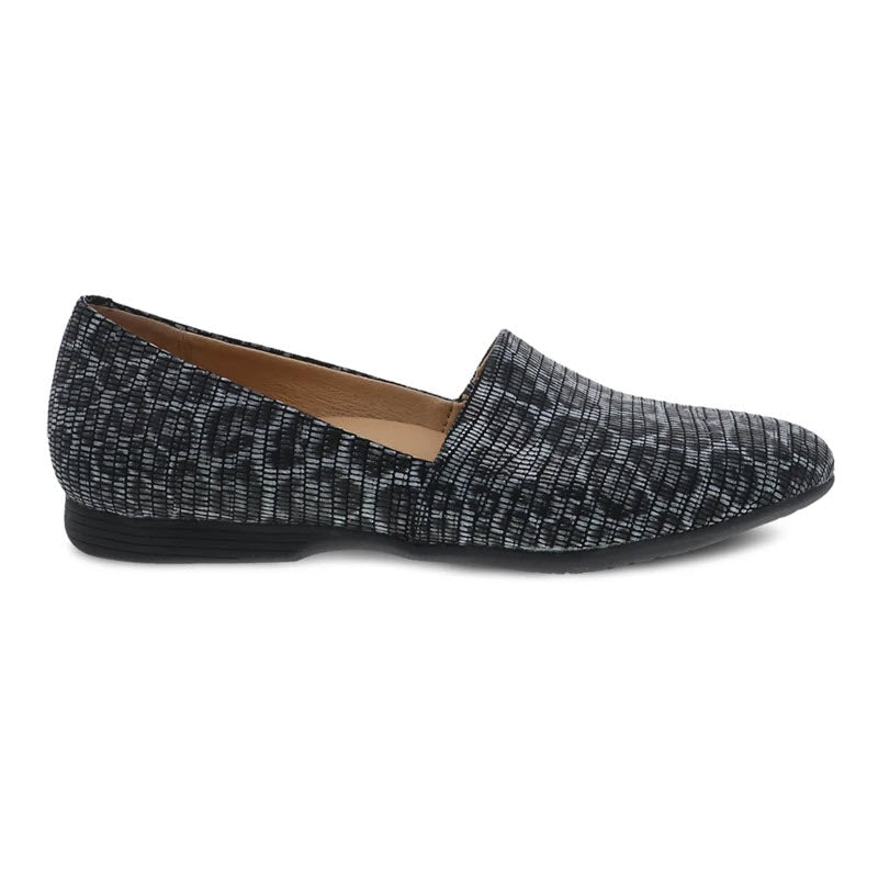 The Dansko Larisa in grey leopard is a textured women's slip-on flat shoe with a rounded toe, low heel, and excellent arch support.