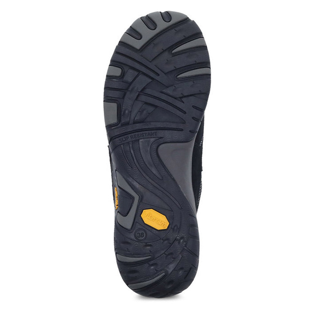 Black and grey shoe sole with textured tread patterns, a yellow Vibram logo, and a slip-resistant Vibram outsole on the DANSKO PAISLEY BLACK/BLACK SUEDE - WOMEN by Dansko.