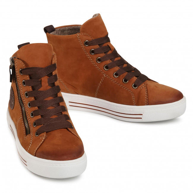 A pair of REMONTE WOOL LINED HIGH TOP TAN - WOMENS by Remonte with white soles, brown laces, side zippers, and a padded soft foam insole for added comfort.