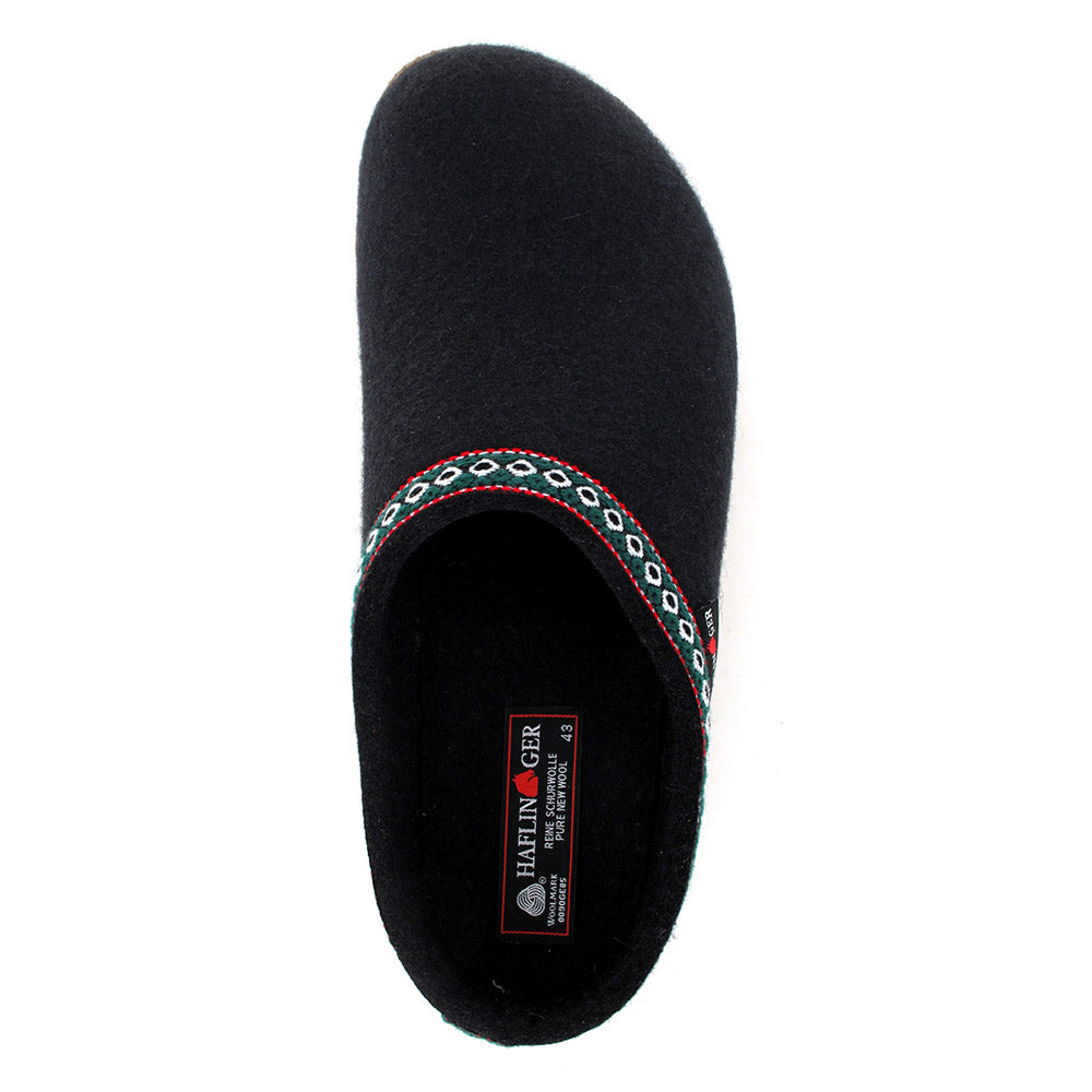 Top view of a single black slipper, the HAFLINGER GZ BLACK - ADULTS, featuring a patterned band and a visible brand label reading &quot;Haflingers,&quot; with its cozy wool felt upper and anatomical cork footbed providing optimal comfort.