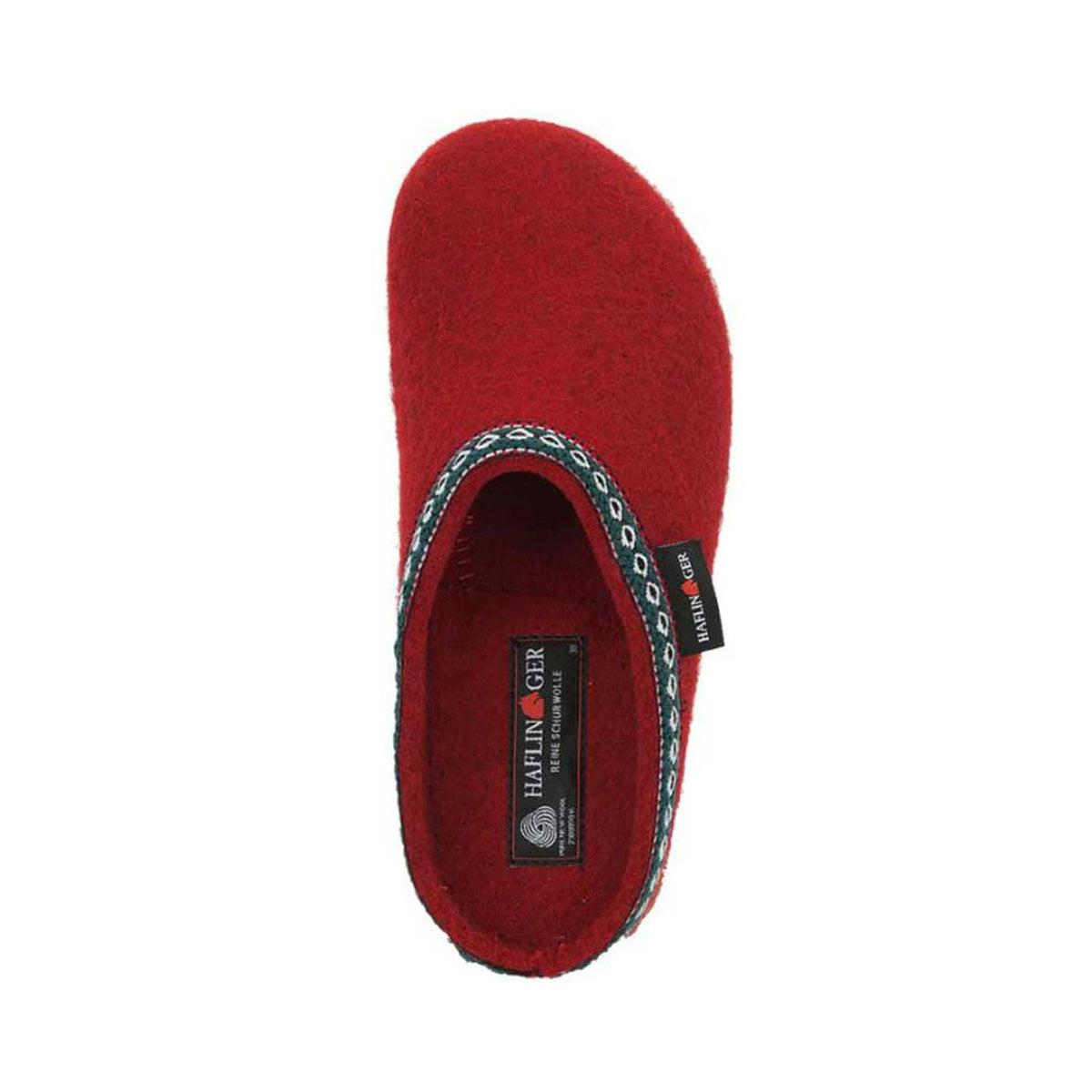 A red HAFLINGER GZ CHILI - WOMENS with a black label and decorative trim around the opening, made from cozy boiled wool felt. The slipper features an anatomically correct footbed for maximum comfort and displays the brand name &quot;Haflingers&quot; on the label.