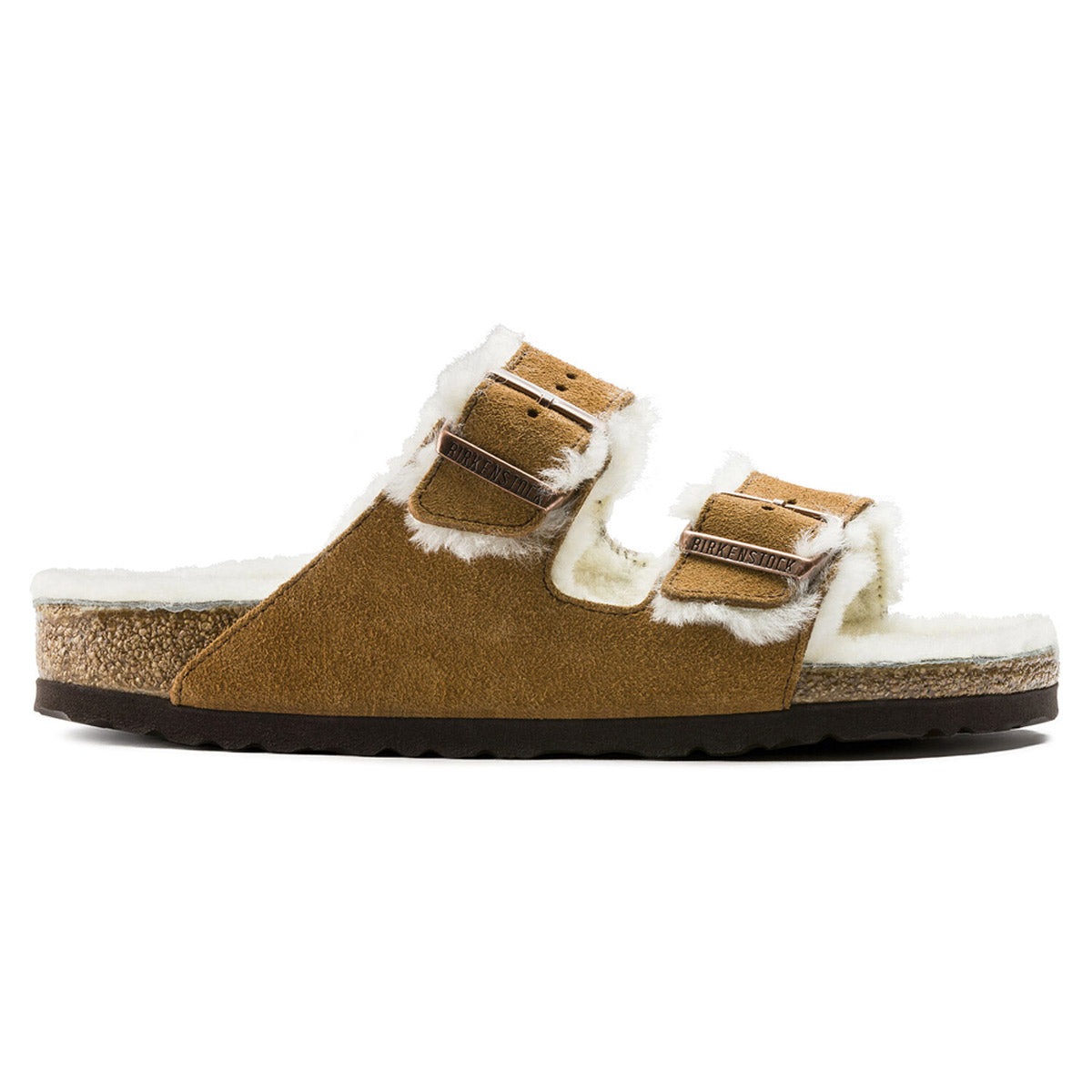 The BIRKENSTOCK ARIZONA SHEARLING MINK for women by Birkenstock is a brown suede sandal with two buckle straps, genuine shearling lining, an anatomically formed cork-latex footbed, and a black rubber sole.