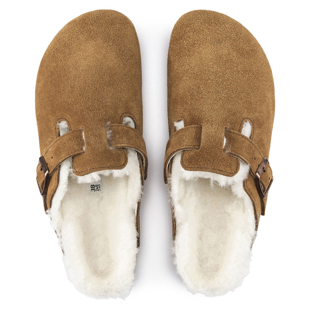 A pair of BIRKENSTOCK BOSTON SHEARLING MINK - WOMENS by Birkenstock, featuring a cozy white faux fur lining and a cork-latex footbed reminiscent of the Birkenstock Boston Shearling design.