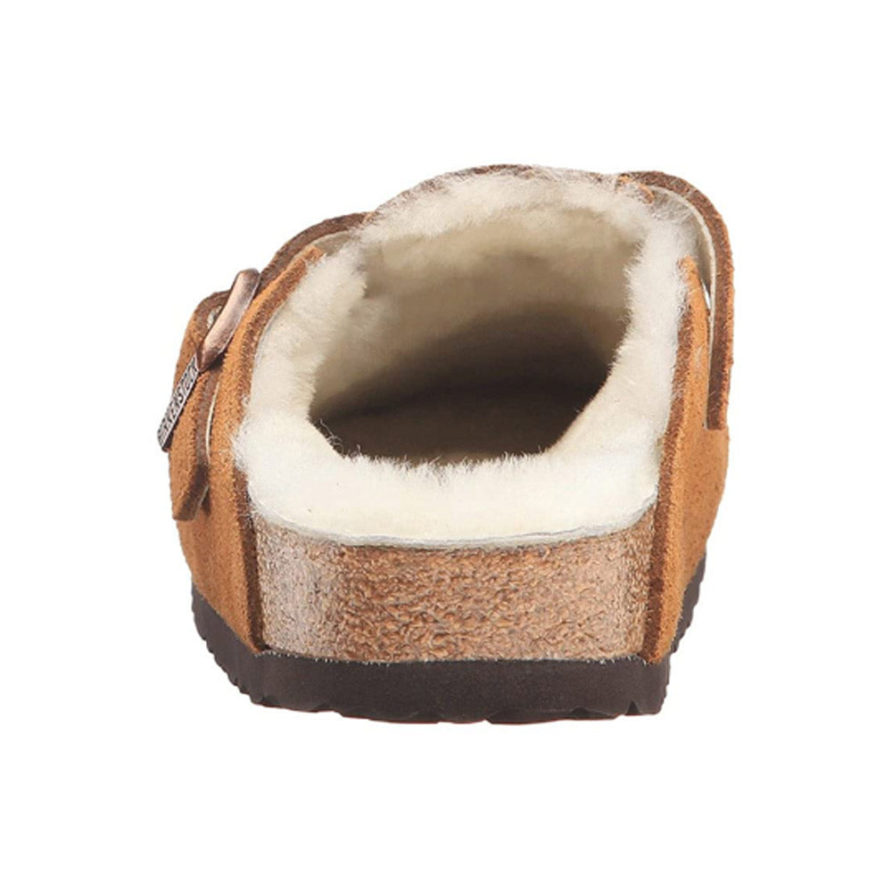 A close-up view of the back of a BIRKENSTOCK BOSTON SHEARLING MINK - WOMENS slipper by Birkenstock, with a fluffy white interior lining and a cork-latex footbed.