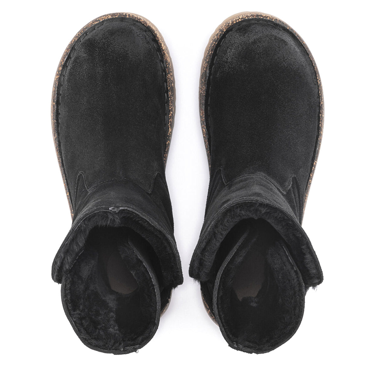 Top view of the BIRKENSTOCK UPSALLA SHEARLING BLACK SUEDE ankle boots for women, featuring a black fur-lined interior, textured sole, and rolled-down shearling lining by Birkenstock.