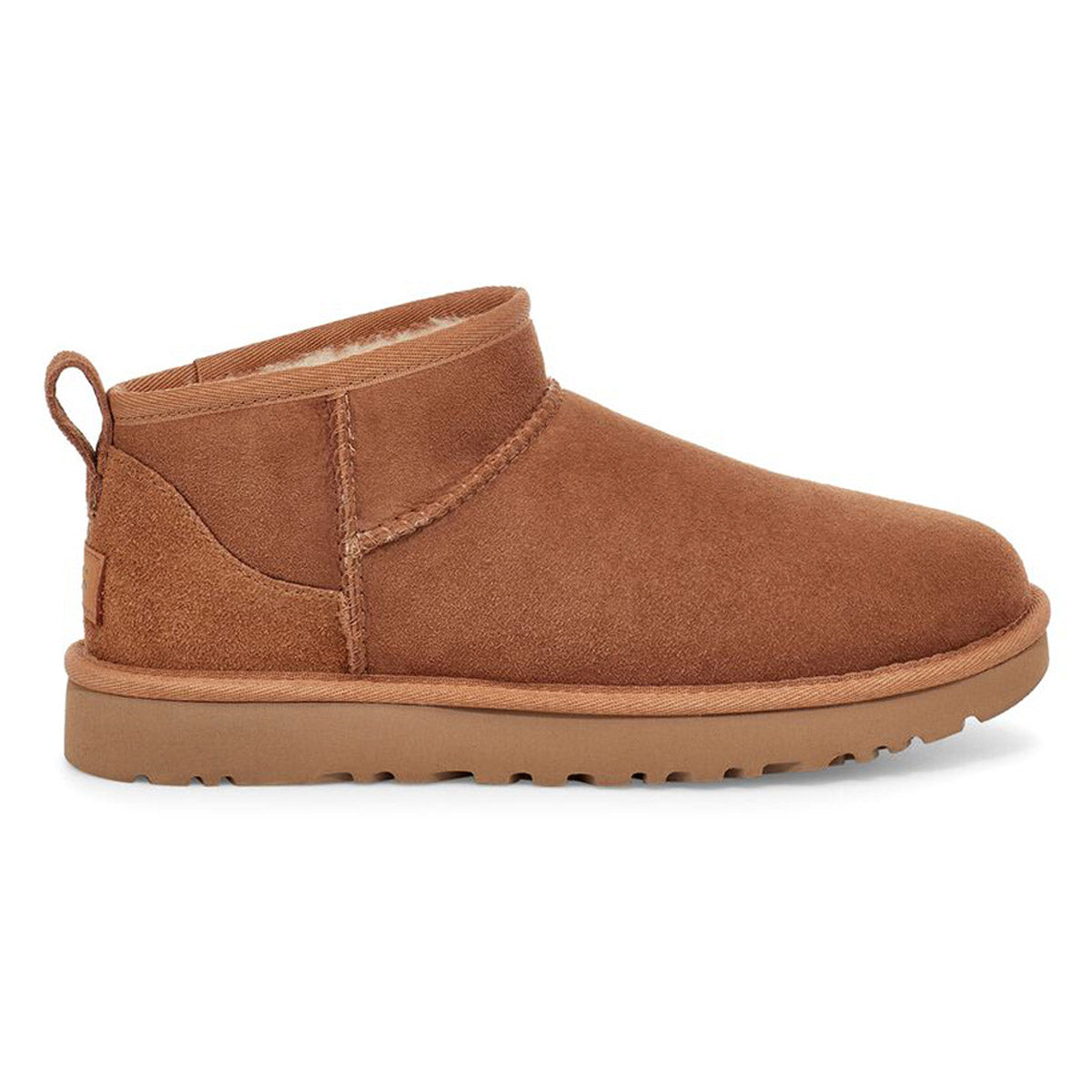 Side view of a UGG CLASSIC ULTRA MINI CHESTNUT - WOMENS by Ugg with a Treadlite by UGG rubber sole and a pull-tab on the back.