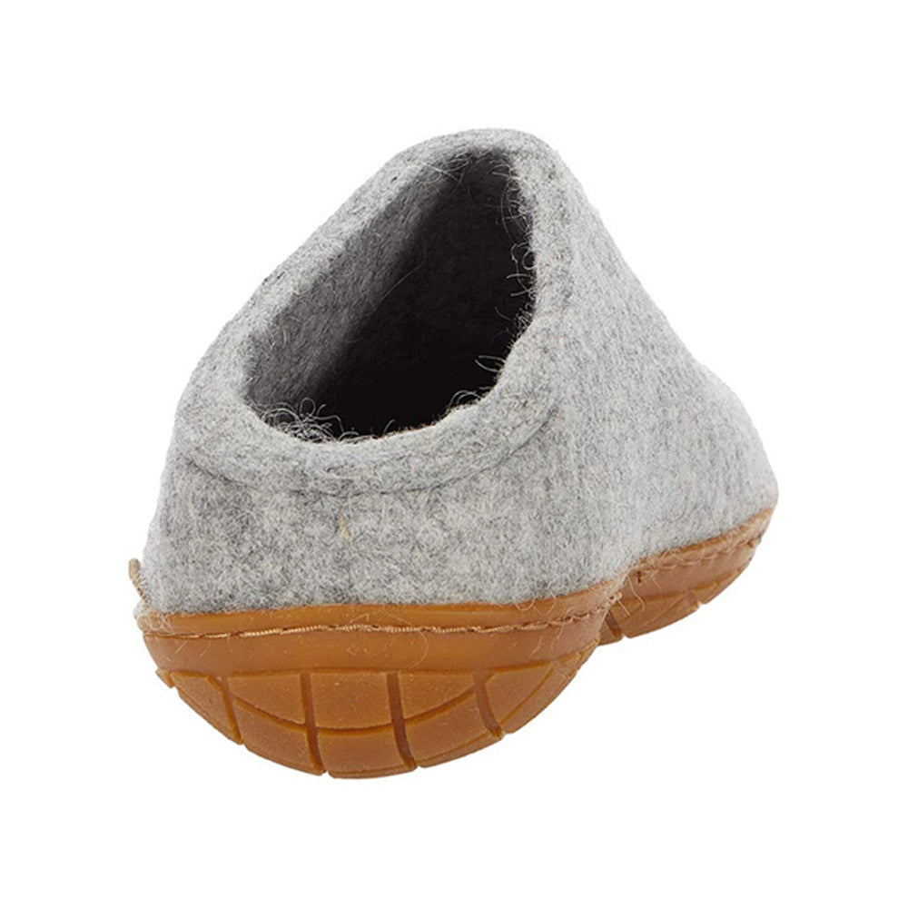 A grey, textured natural wool slipper with a brown rubber sole is shown from the back view, resembling the cozy and durable design of GLERUPS THE SLIP-ON RUBBER HONEY GREY - ADULTS by Glerups.