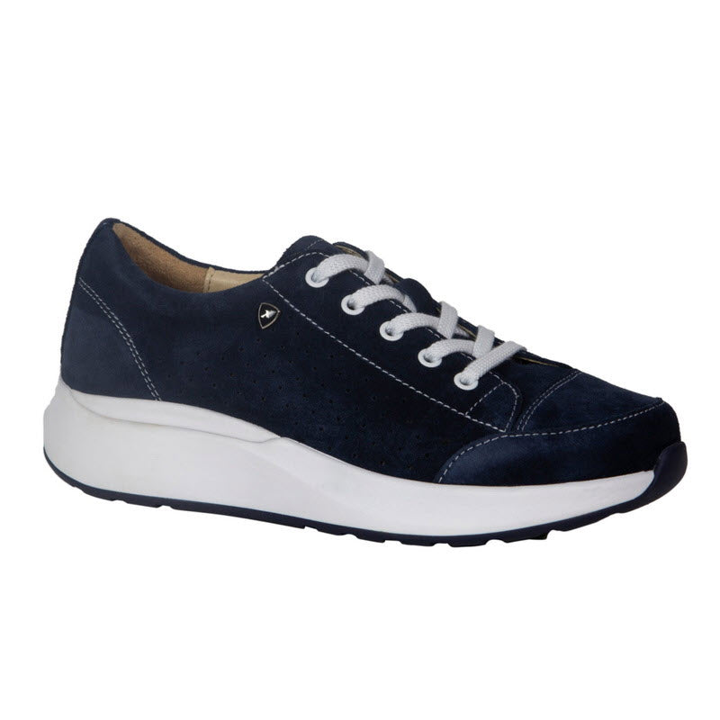 A dark blue sneaker with white laces and stitching details, featuring a thick white rubber sole, shown from a side angle. Part of the Suisse Collection, this Xelero Heidi Deep Ocean walking shoe combines style and comfort.