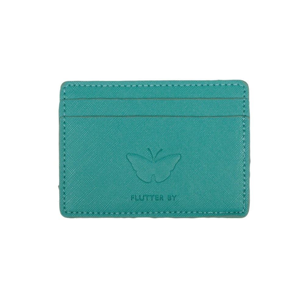 A turquoise Sophie cardholder with two card slots on top, an embossed butterfly design in the center, and the text &quot;FLUTTER BY&quot; below the butterfly. Made from textured faux leather, it combines elegance and practicality. Introducing the SOPHIE ALLPORT CARD CASE BUTTERFLIES by Sophie.