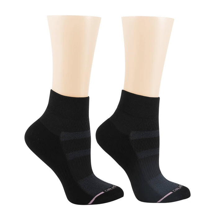 Pair of DR MOTION QUARTER HEIGHT COMPRESSION SOCK BLACK by Dr. Motion with seamless reinforced toe displayed on beige mannequin feet against a minimalist background.