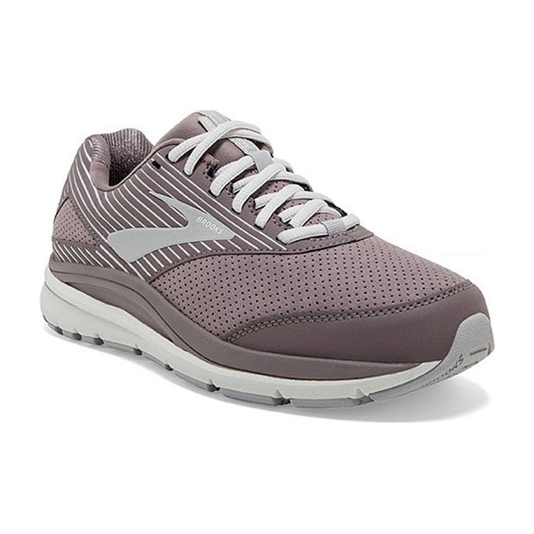 The Brooks Addiction Walker Suede Shark/Alloy for women is a single mauve athletic shoe with white laces and white and gray accents. It features a perforated design, a cushioned sole, and includes the BioMoGo DNA midsole for added comfort.