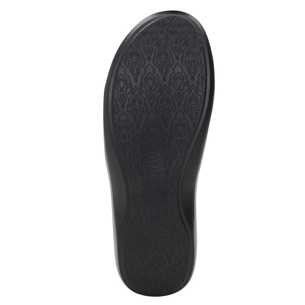 Bottom view of the Alegria ALEGRIA DUETTE BLACK WOVEN - WOMENS nursing shoe sole with an intricate embossed pattern and a slip-resistant outsole.