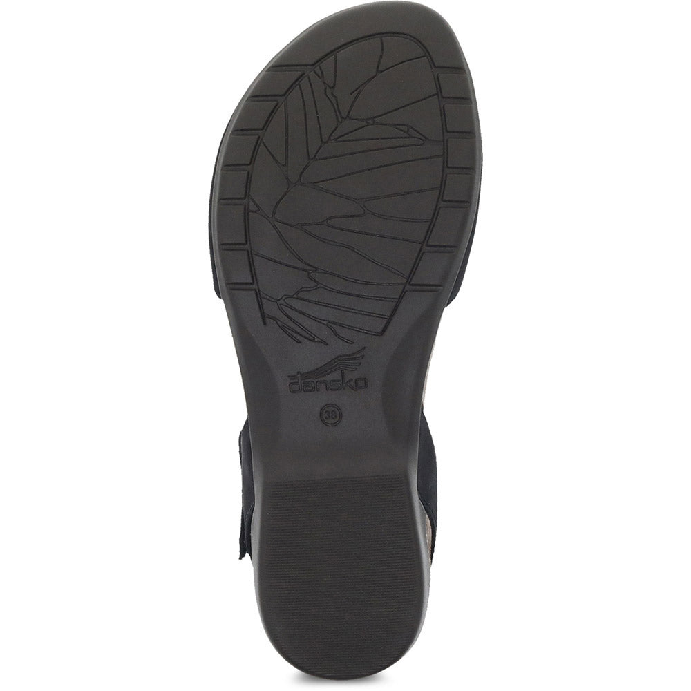 The image shows the bottom sole of a black Dansko Rowan shoe, featuring a textured leaf pattern design and the brand name &quot;Dansko&quot; near the center. This stylish summer sandal also boasts memory foam footbeds for added comfort.