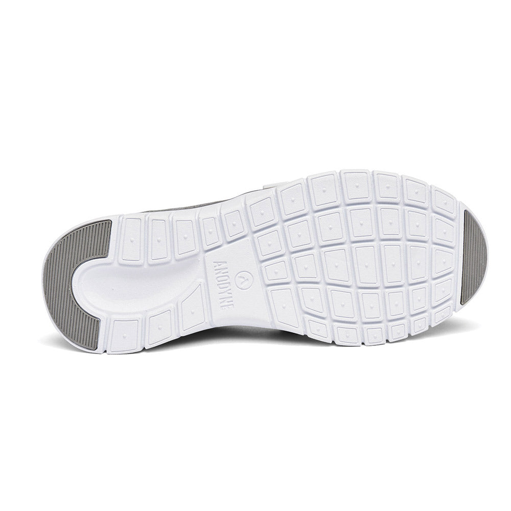 A shoe sole made of white rubber featuring a grid-like tread pattern and the Anodyne Sport Trainer logo embossed in the center, displayed against a plain white background. The sole is from the ANODYNE SPORT TRAINER GREY – WOMENS by Anodyne.