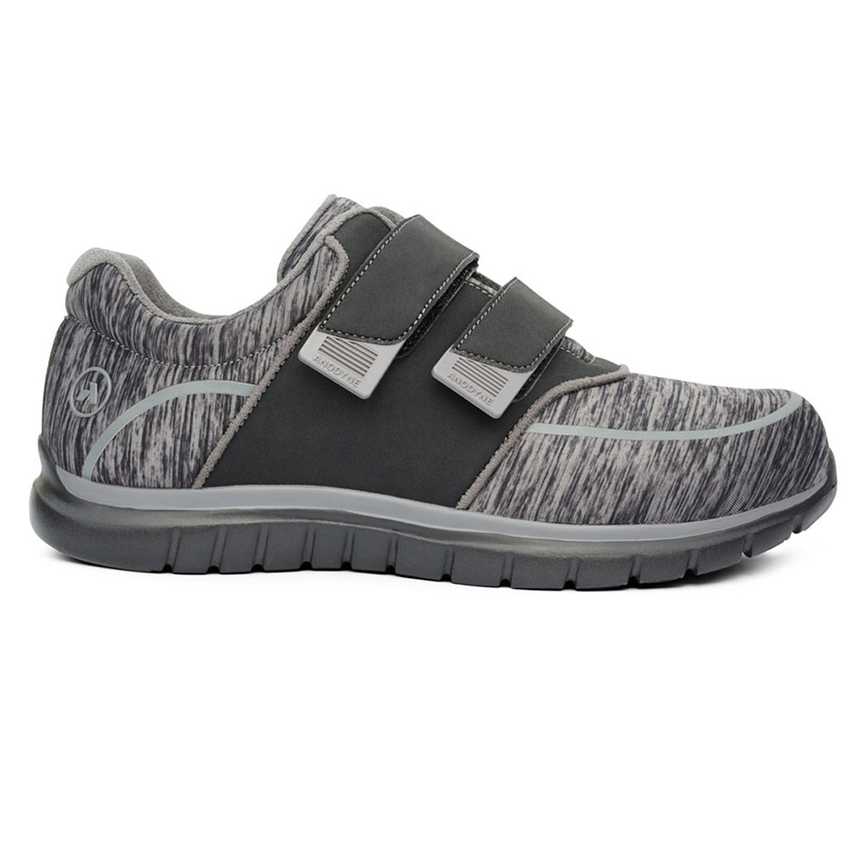 The Anodyne Sport Jogger Double Depth in Black/Grey for women features a single grey athletic shoe with a textured sole and two Velcro straps. It showcases a dark grey side panel and a logo on the heel. This orthopedic-friendly design also includes extra depth for enhanced comfort.