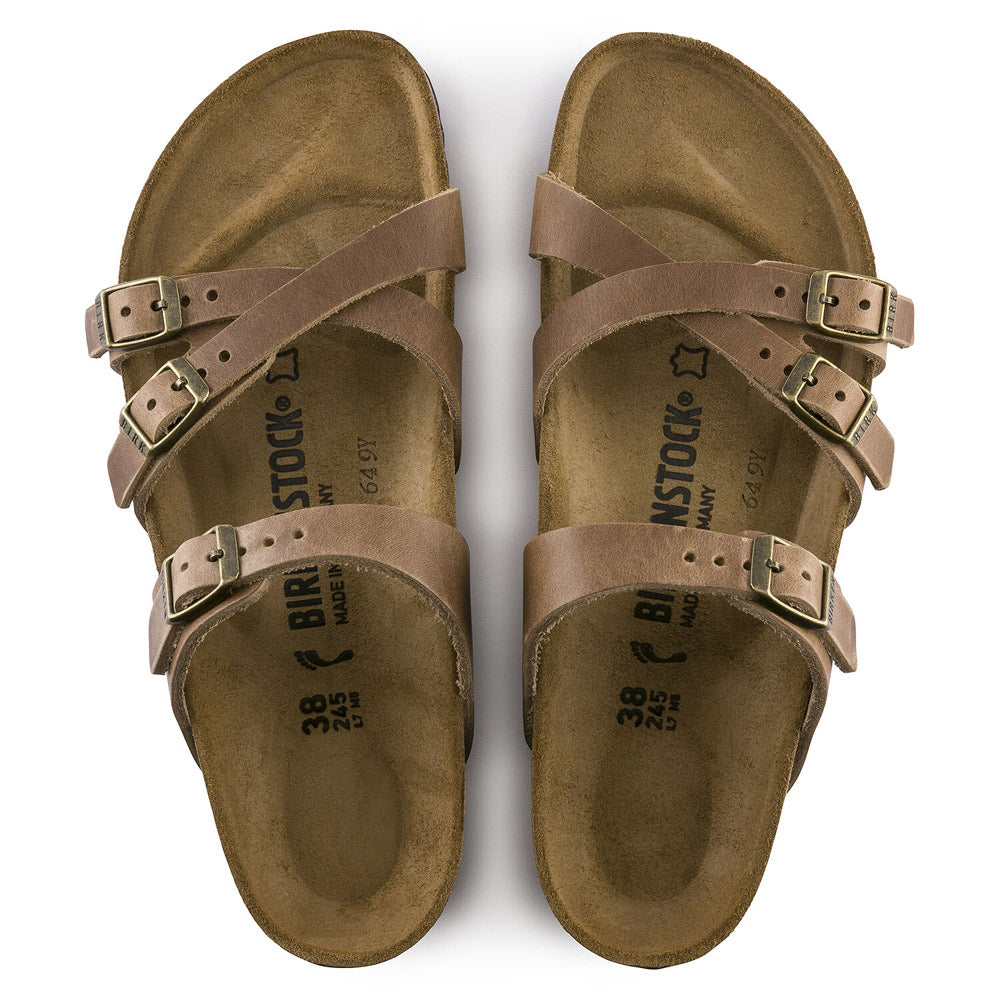 The BIRKENSTOCK FRANCA TOBACCO - WOMENS sandals by Birkenstock are crafted from oiled leather and feature three adjustable straps, buckle closures, and an anatomically shaped footbed.