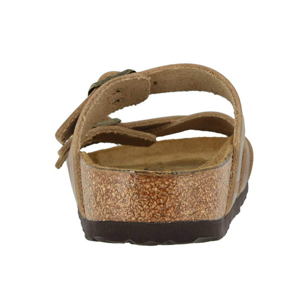 A rear view of the BIRKENSTOCK FRANCA TOBACCO - WOMENS sandal by Birkenstock, featuring a cork sole, adjustable straps, and an anatomically shaped footbed in oiled leather.