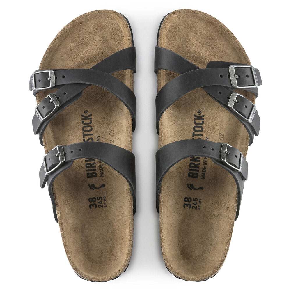 The BIRKENSTOCK FRANCA BLACK - WOMENS sandals, crafted by Birkenstock from oiled leather, feature adjustable straps and buckles. The insole displays size markings and branding, supported by a comfortable cork-latex footbed.