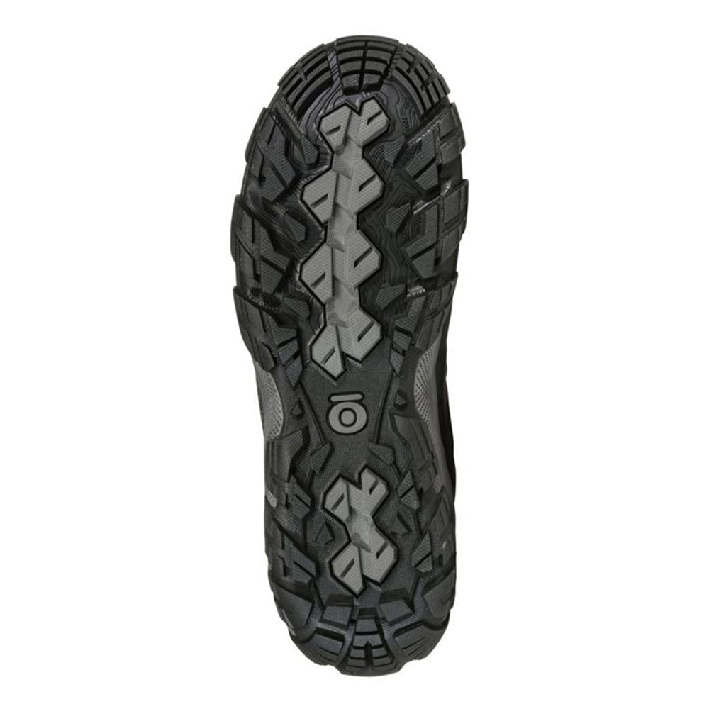 Close-up of the sole of an Oboz OBOZ SAWTOOTH X MID B-DRY CHARCOAL - WOMENS, showcasing a rugged, multi-directional tread pattern for reliable traction.