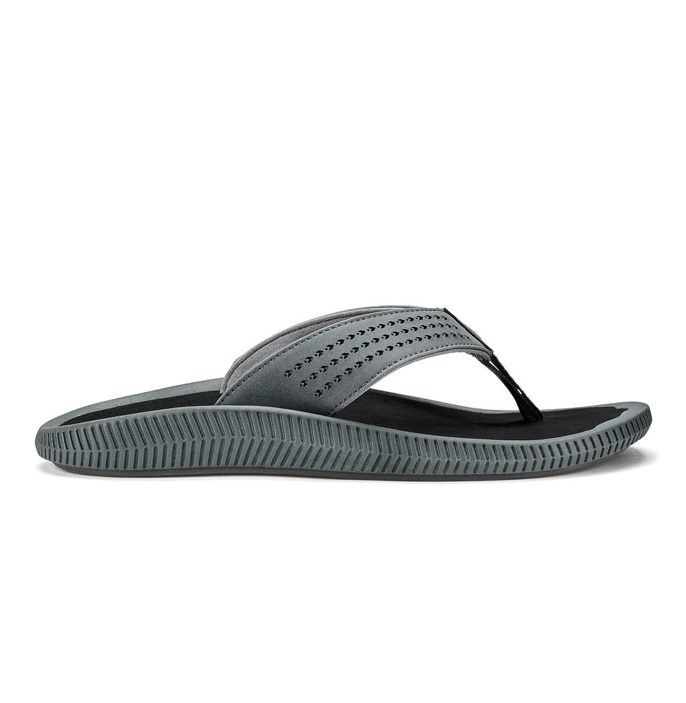 Side view of a single dark shadow-colored, water-friendly sandal with a textured sole and perforated strap; meet the Olukai Ulele Dark Shadow - Mens.